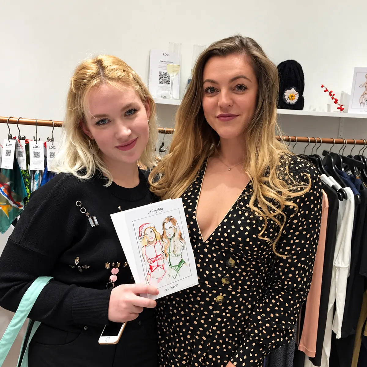 Two guests with their fashion sketch at a boutique