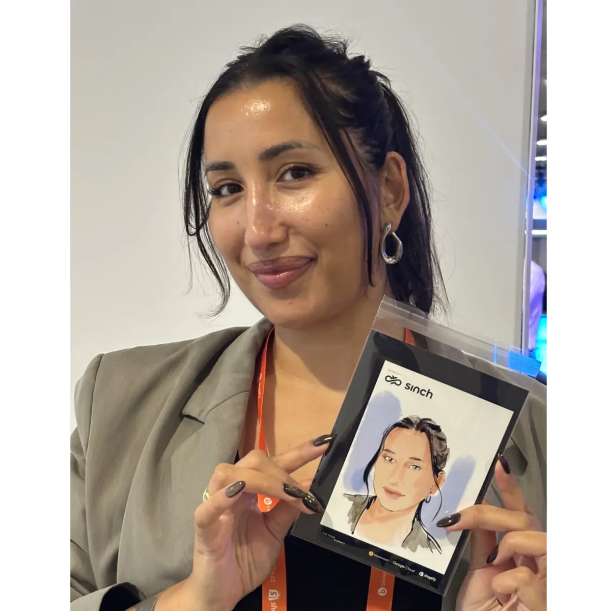 Guest holding her framed portrait at a corporate event