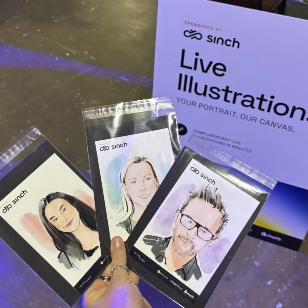 Stack of finished guest portraits at a live illustration stand